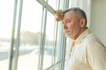 Sad tired lonely disappointed older senior man at home alone. Unhappy grandfather looking sadly...