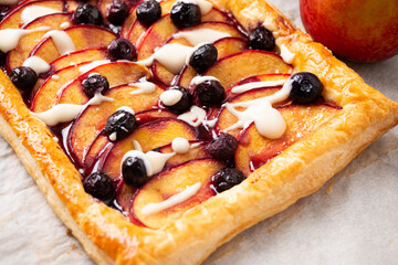 Close up of nectarine and blueberry pie with vanilla glaze
