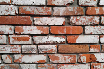 Brick dilapidated wall masonry of red bricks with white coating