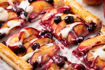 Close up of nectarine and blueberry pie portions