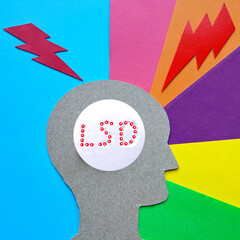 The effects of LSD on the brain cardboard image of a person against a background of different colors and lightning with a pill in the brain