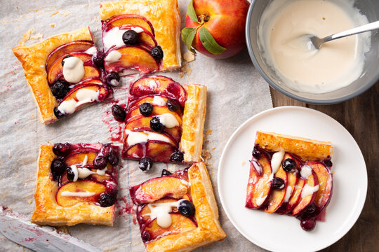 Homemade nectarine and blueberry puff pastry tart with vanilla glaze - Powered by Adobe