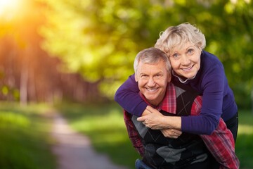 Portrait of old cheerful people walking in forest