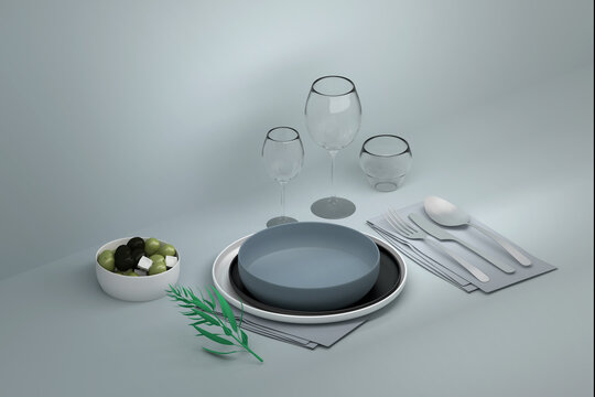 Dining table with plates, cutlery, and glassware, adorned with a composition of olives in shades of green and black wuth a blue tableclothon blue background. 3d render.