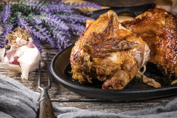 Quarters of fried chicken in a cast iron skillet.