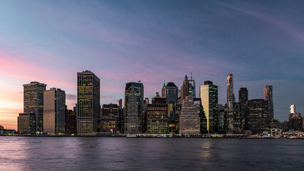Naklejka premium Skyline of lower Manhattan during the twilight seen from Brooklyn Bridge Park, New York