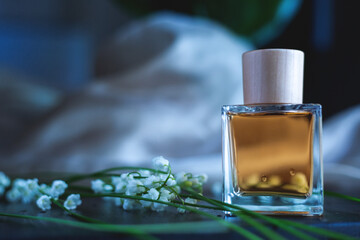 Bottle of stylish perfume and flowers