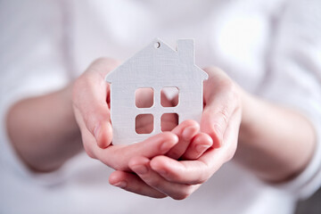 Real estate agent holding house model