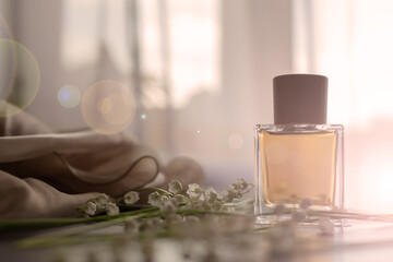 Perfume essence bottle and flowers