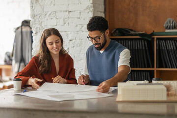 Young couple working as architects in the office.