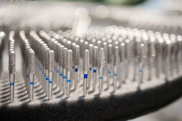 Collection of dental tungsten burs, dental equipment, tools in row - close up, selective focus....
