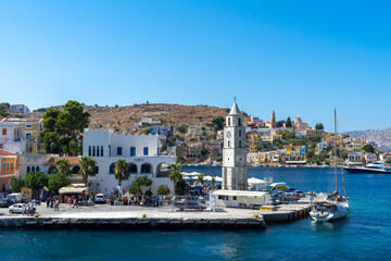 Clock Tower and houses of island Symi or Simi, Greek mountainous island and municipality, part of...