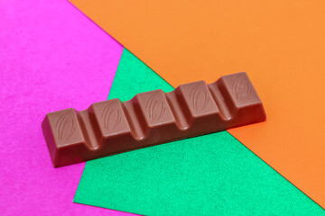 Milk chocolate bar on colorful paper