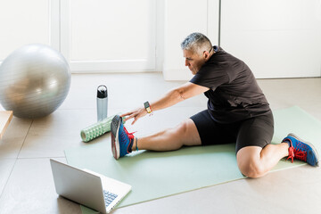 Overweight adult female doing stretching and sport indoors
