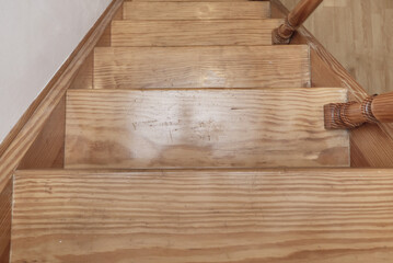 Stairs in varnished pine wood with balusters