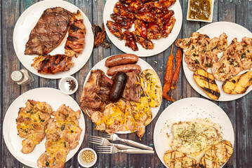Still life with plates of food cooked on the grill, with chicken fillets,