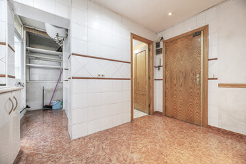 Fototapeta na wymiar Bare kitchen wall with light brown speckled stoneware flooring