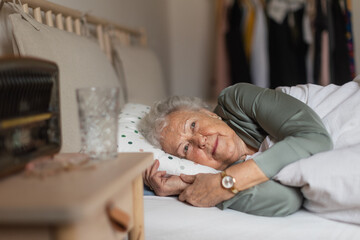 Senior woman sleeping in her bed alone.