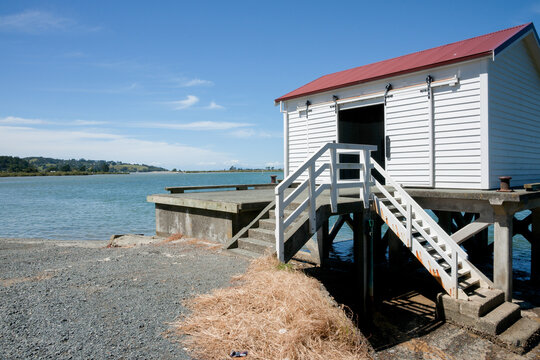 Open wharf shed with view across bay at Big Omaha, New Zealand..