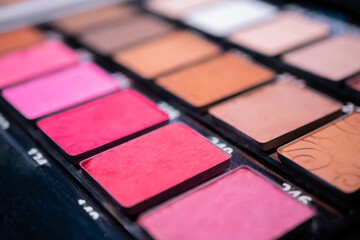 Close up, selective focus: professional rouge pallet for make up in cosmetic store. Makeup, beauty, fashion and glamour concept