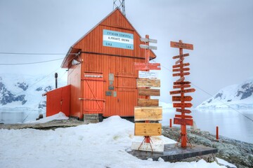 Photo of a red building standing in the snow-covered landscape of Antarctica