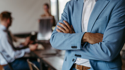 Close up of businessman with crossed arms.