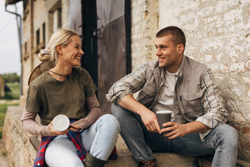 A man talks to a beautiful woman on the stairs.