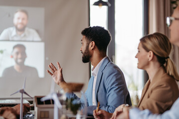 Young colleagues having meeting, consulting about green energy.