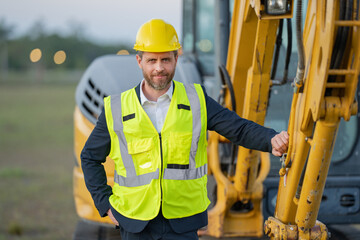 Civil engineer worker at a construction site. Engineer man in front of house background. Confident...