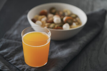 orange lemonade in glass tumbler glass on black wood table