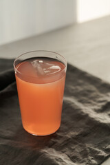 Guava drink in tumbler glass on linen cloth