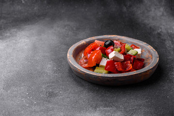 Delicious fresh juicy greek salad with feta cheese, olives, peppers and tomatoes