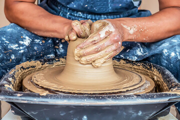 Close-up of potter's hands at work.Handmade in a pottery workshop.