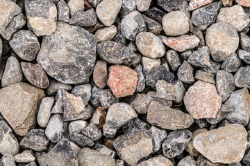 Building material stone rubble on road surface as background