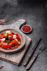 Delicious fresh juicy greek salad with feta cheese, olives, peppers and tomatoes