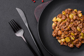 Tasty dish consisting of zucchini, beef meat, mushrooms, onions and garlic