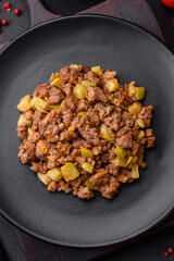 Tasty dish consisting of zucchini, beef meat, mushrooms, onions and garlic