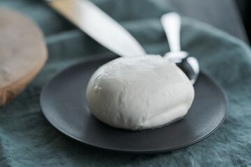 mozzarella ball on small ceramic plate
