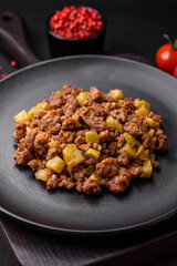 Tasty dish consisting of zucchini, beef meat, mushrooms, onions and garlic