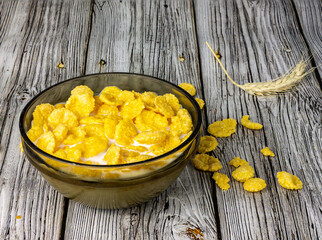 Corn flakes with milk in a plate close-up