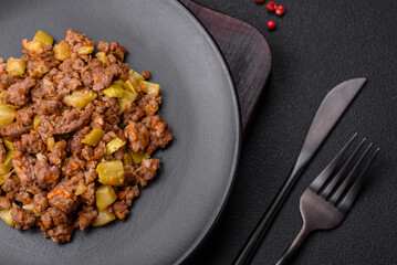 Tasty dish consisting of zucchini, beef meat, mushrooms, onions and garlic