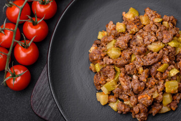 Tasty dish consisting of zucchini, beef meat, mushrooms, onions and garlic