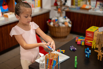 preschool girl child playing with educational toys and colors