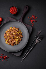 Tasty dish consisting of zucchini, beef meat, mushrooms, onions and garlic