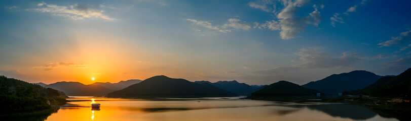 panorama Mountains forest lake landscape in rainy season with sunset sky and clouds background,...