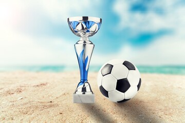 Beautiful trophy with football Ball on sand
