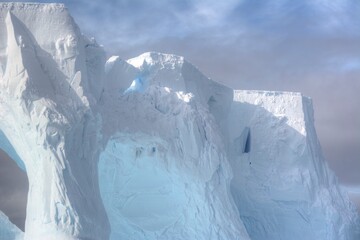 Photo of a massive iceberg floating in the frigid waters of Antarctica during expedition season
