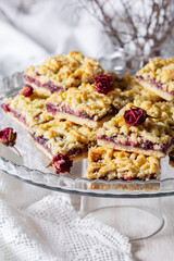 Streusel pie with currant and rose petal filling on a light background.