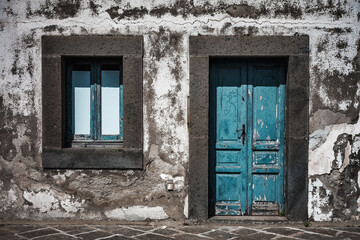 the entrance of a rustic house shows the signs of time