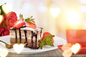 Piece of tasty sweet cake and cup of tea, roses